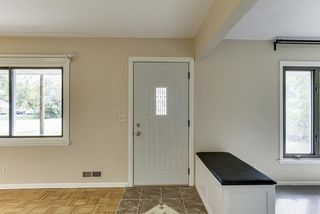 Front door with ceramic tile entry, great use of space with storage bench