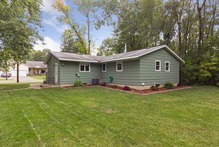 Back of home is lovely with the fresh landscaping wrapping around