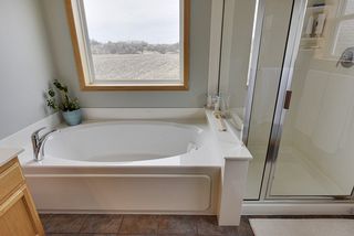 Separate tub and shower with picture window.