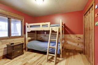 The Main floor second bedroom is spacious, plank hardwood flooring and wainscotting gives that lodge- like feel.