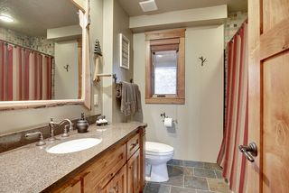 The main floor Bath has a slate tile floor, fully tiled bath/shower complimented by custom mirrors and a large vanity with a granite top and integral bowl sink.