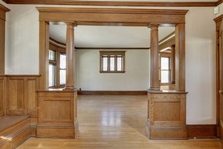 View from the Entry Foyer into the Living Room. There are Original Leaded Glass Windows everywhere you look! 