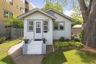 White stucco, sharp grey accents, landscaped, fully fenced yard.