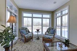 this tranquil four season sun room will draw you back to relaxation and rest
