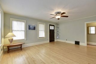 The large Living Room features Hardwood Floors & lots of windows! 