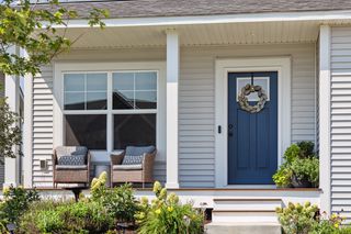 Notice the craftsman-style front door in a serene blue as you walk up the steps.
