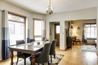 Spacious living room with gorgeous hardwood floors and original stained glass windows.