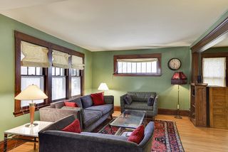 Living room with piano window and built in book shelves.
