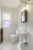 Pedestal sink and tile floor.