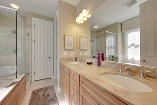 The master bath features double sinks, private toilet, tile flooring and linen closet.