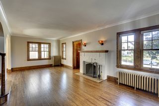 Sunshine filters through windows, reflecting on newly refinished floors. 