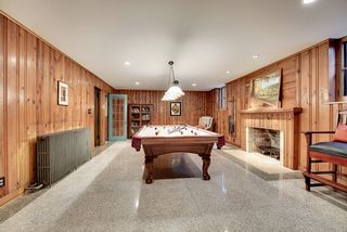 The Lower Level Billiard Room features a Fireplace and original Terrazzo Floors.