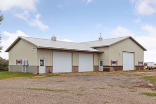 Pole shed features 32 x 40 shop with bathroom, heat and air conditioning.  40 x 72 storage area