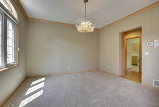 Formal Dining Room off the Kitchen and Foyer. West facing windows stream the afternoon sun.