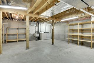 Basement level laundry and storage area with plenty of room for shop or craft room. 