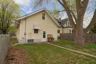 Back side of house with large shade tree.