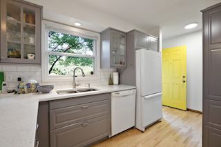 Back door to the expansive back yard and large two car garage. Steps to the Lower Level are off the Kitchen