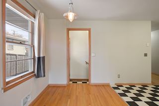 Stairs to the finished lower level is off the Dining Room/Kitchen. The side door to the wood deck and walkway to the detached garage is through the door ahead.