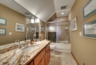 Guest Bathroom in upstairs hallway, granite vanity top. tiled, tub shower area.