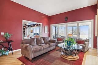 Family room  and porch.  The walls are a much richer color vs the bright red!