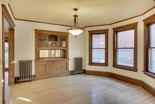 The Dining Room features this Bay Window, Hardwood Floors & Original Built-In Buffet.
