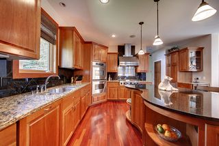 Large, sculpted, American Cherry working kitchen island with granite surface.