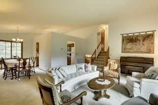 Another view of living and dining areas. Stairs go up to bedrooms and bathroom, down to foyer and family room.