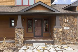 A dry laid fieldstone path leads you to the large, covered, Front Entry Porch Area.