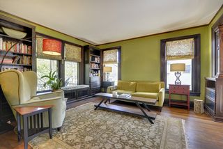 The Living Room features Hardwood Floors, Huge Windows & Built-In Book Shelves...
