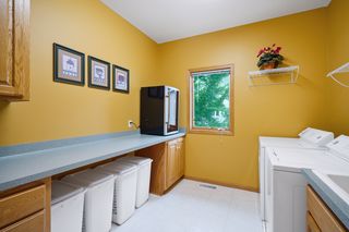 Main floor laundry room with utility sink, storage cabinets and work space.  Washer and dryer stay with the house.
