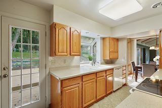 Door to back yard from the Kitchen with bay window
