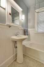 The Bright & Cheery Bathroom features a Pedestal Sink...