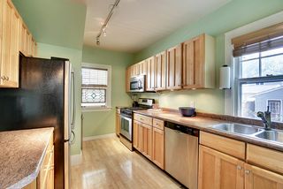 The Light-Filled Kitchen offers plenty of Cabinet Space and Stainless Steel Appliances...