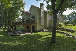 Boulder retaining wall, sprinkler system, large patio and deck