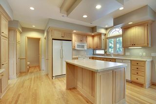 A large Kitchen sink area window floods this kitchen with morning sunlight. 