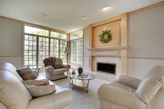 Molded woodwork patterns and a custom fireplace surround flank the fireplace.