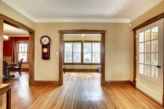 The Light-Filled Main Floor features Hardwood Floors and Original Woodwork...