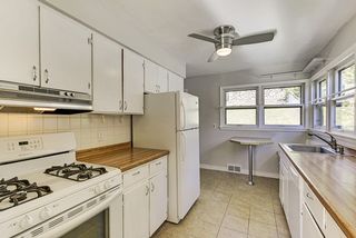 The "Galley Style" Kitchen offer plenty of Cabinets & Corner Windows!