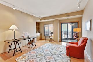 Den adjoining Living room with entrance to three-season porch, wet bar.