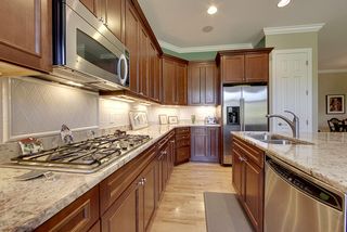 The kitchen features GE sears appliances: dishwasher, double oven, five burner cooktop, microwave, and refrigerator.