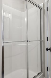 The owners' walk-in shower gleams and is fresh, clean and bright.