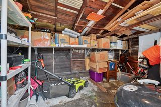 Attached Shed has concrete floor with shelving .