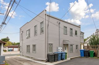 Rear/North facing view of 4 plex features all new Vinyl and Wood Siding, new Vinyl Window Wrap. New Vinyl Windows 2023 throughout. There are Glass Block windows in all 4 bathrooms. Newer Steel doors on front and rear of building.