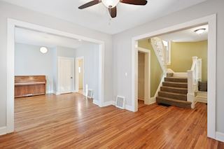 Living room with dining room on left and foyer on right