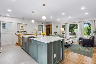 Terrazzo-look floors, an art niche with original retro light fixture blend the mid-century vibes with modern conveniences like the cabinet-faced dishwasher to the left of your huge 36" apron sink - you deserve this kind of life