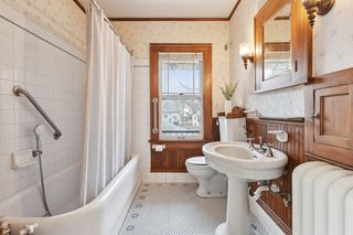 upper full bath with original woodwork and tile