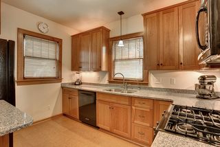 Gleaming Silestone counters, gas range, wood blinds and dual sink