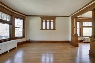 The Large Living Room features Hardwood Floors, Columns & Original Leaded Glass Windows.