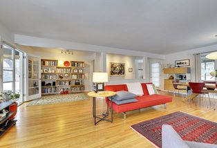 The Large Living Room features Gleaming Hardwood Floors and east access to the Front 3-Season Sunroom...