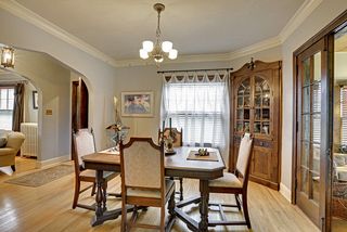 The Dining Room features a Period Light Fixture, Two (2) Built-In China Cabinets & Hardwood Floors! 